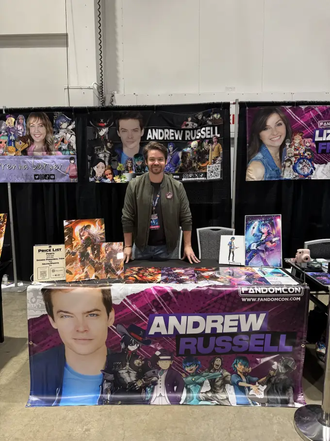 Andrew Russell meeting a fan at a stocked autograph table