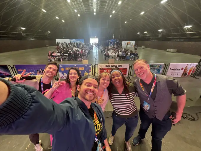 Andrew Russell taking a large group selfie with convention attendees