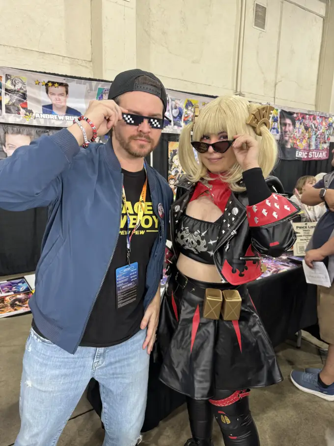 Andrew Russell posing with a cosplayer at a fan convention