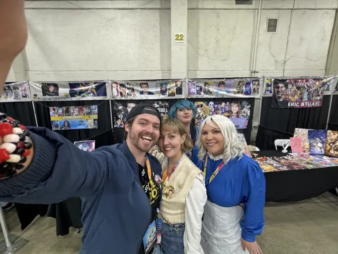 Andrew Russell with convention attendees in front of his signing table