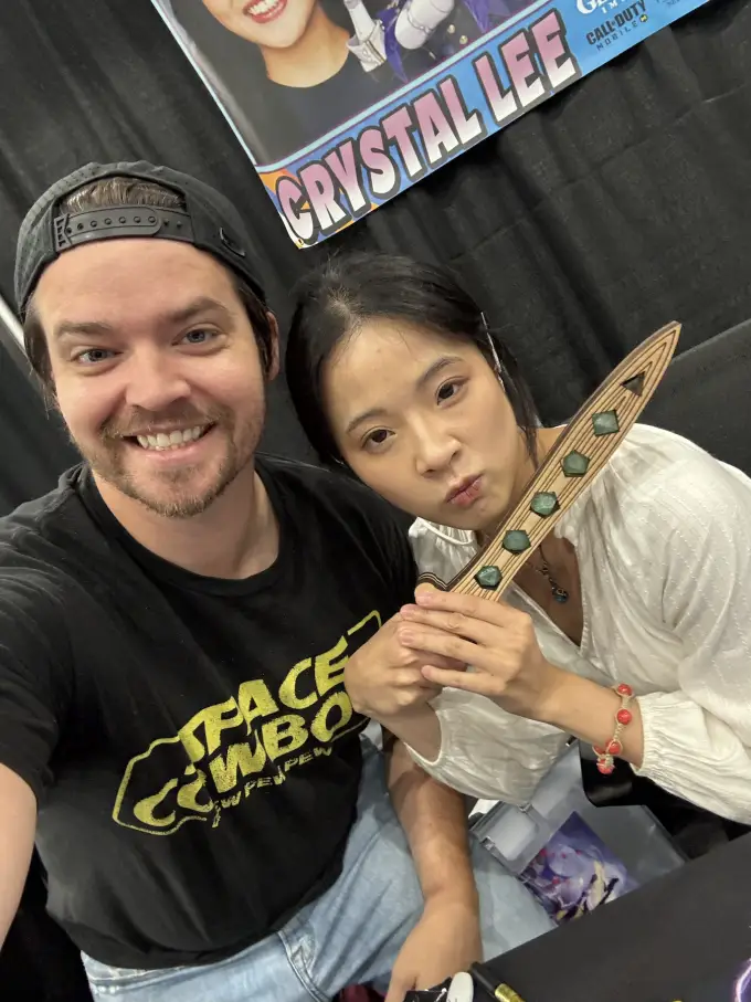 Andrew Russell posing with a fan wearing fantasy costume ears