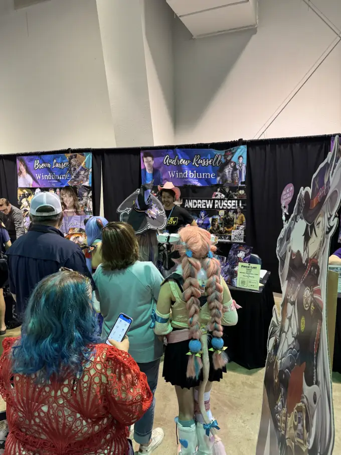 A crowd of fans visiting Andrew Russell's convention table
