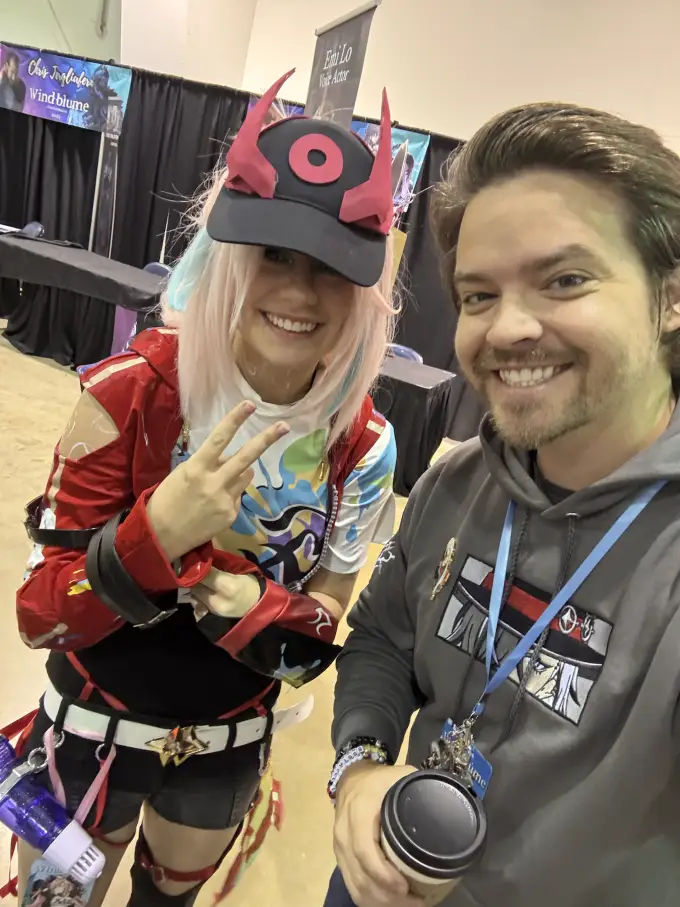 Andrew Russell posing with a costumed fan