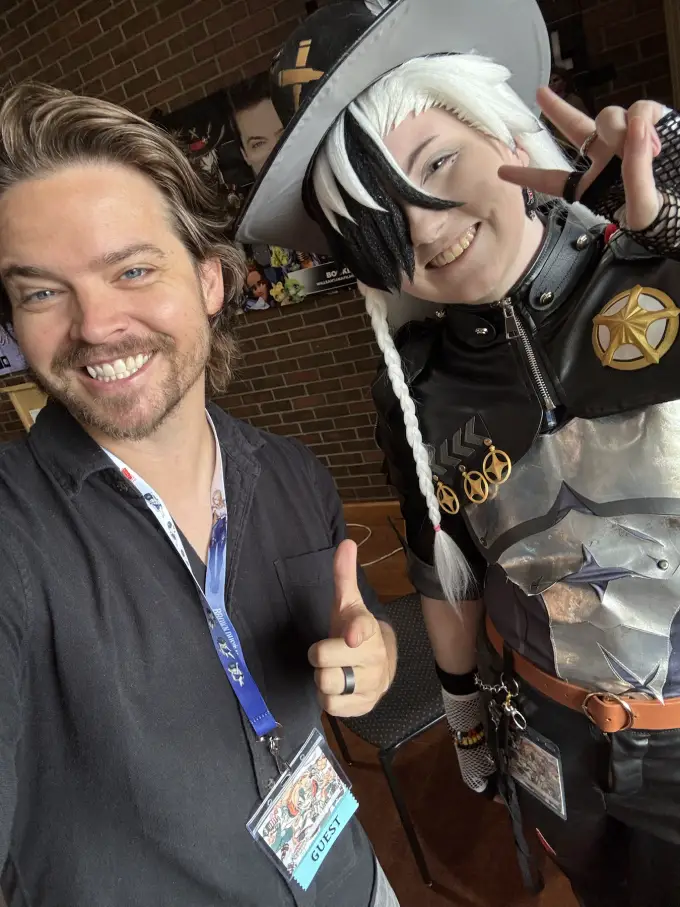 Andrew Russell with a cosplayer at a fan event