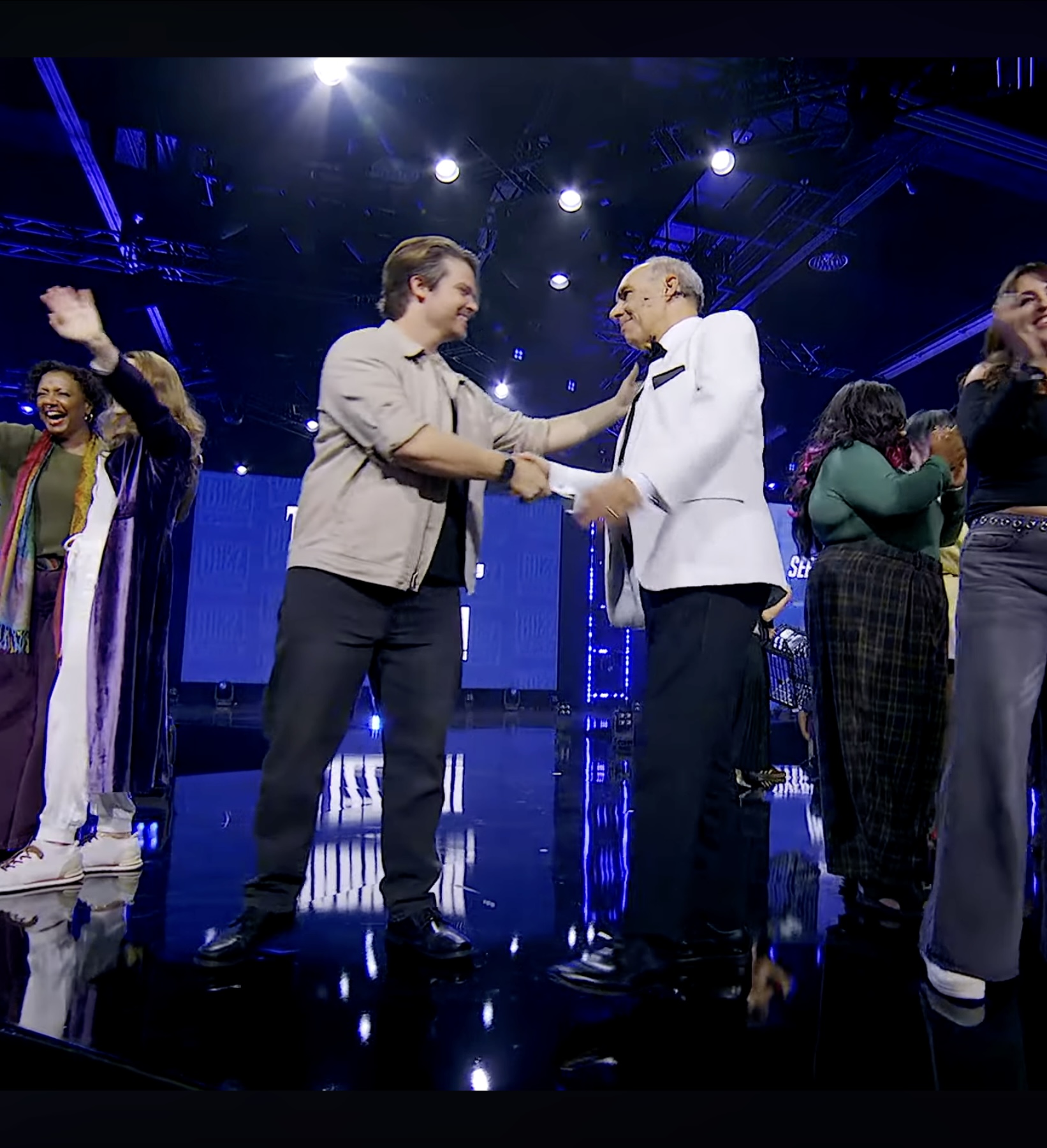 Andrew Russell shaking hands with a fellow BlizzCon guest on the Main Stage
