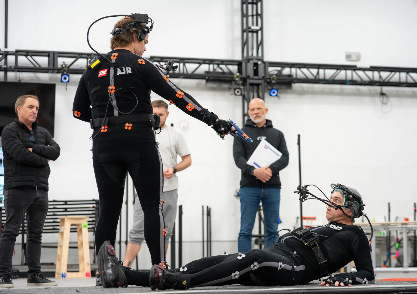 Andrew Russell blocking an action scene with a fellow performance-capture actor and the creative team